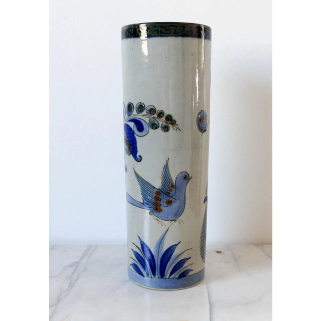 Vintage Mexican pottery vase with birds, butterflies and flowering motif. Signed by artist on bottom. Minor age wear. No...