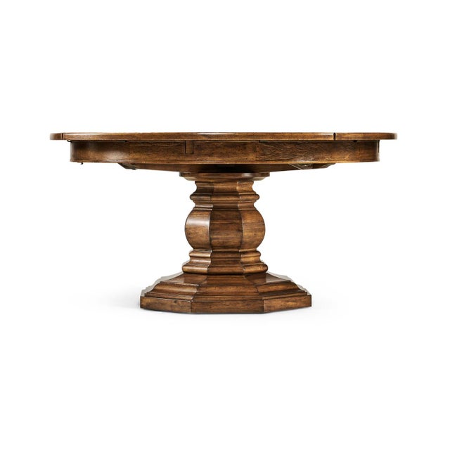 A Provincial 59" walnut-topped circular dining table with a rustic finish showing exposed saw marks set on a substantial...