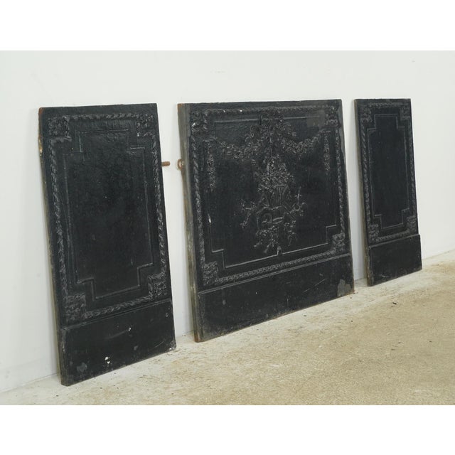 French style fireback panels made of cast iron with a raised ornate basket design. This set is original to The Plaza...