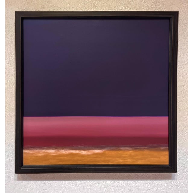 This artwork presents a serene gradient of colors, transitioning from deep purples to soft pinks and warm golds, evoking a...