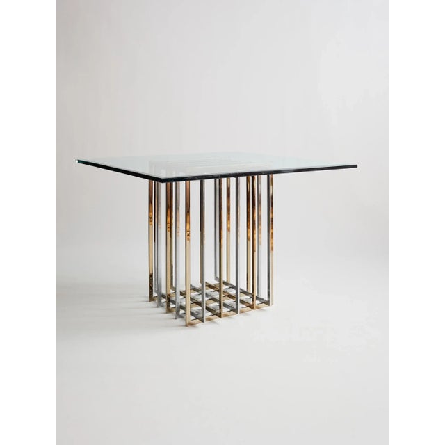 A striking example of mid-century glamour, this Pierre Cardin dining table pairs a clear glass top with a sculptural metal...