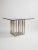 A striking example of mid-century glamour, this Pierre Cardin dining table pairs a clear glass top with a sculptural metal...