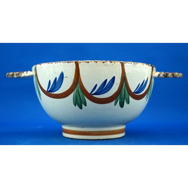 Beautiful large two-handled bowl in glazed ceramic, hand-shaped on a wheel, hand-decorated with floral decorations and...