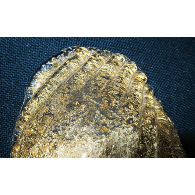 Mid-century Italian conch shaped wall light in gold flecked Murano glass, 1960s. Unusual feature: two large decorative...