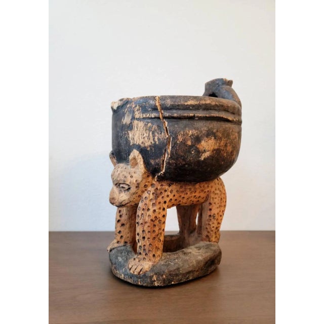 A fascinating Yoruba Peoples carved and painted divination cup / ritual bowl (agree Ifa) Early to mid-20th century, West...