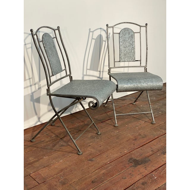 Hand made wrought iron and galvanized aluminum seat and back outdoor folding chairs. Each chair is unique due. Circa...