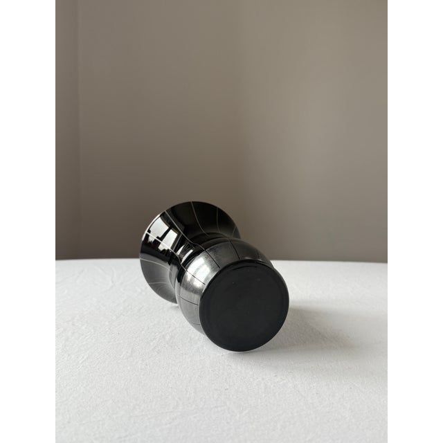 Elegant Art Deco vase made of black hyalith (opaque) glass, featuring hand-painted silver line decoration. The slender...