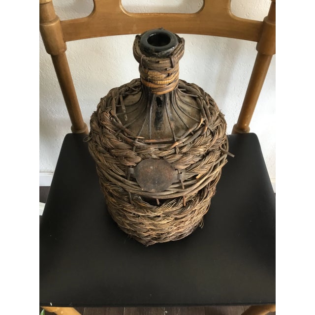 Wonderful sample of history in this French Demijohn. Glass bottle used for wine is wrapped in braided rope like weaves and...