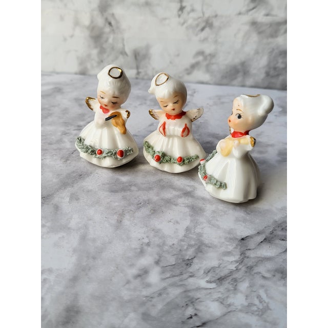 This is a set of vintage miniature Christmas angels figurines playing instruments. Napco is the National Potteries...