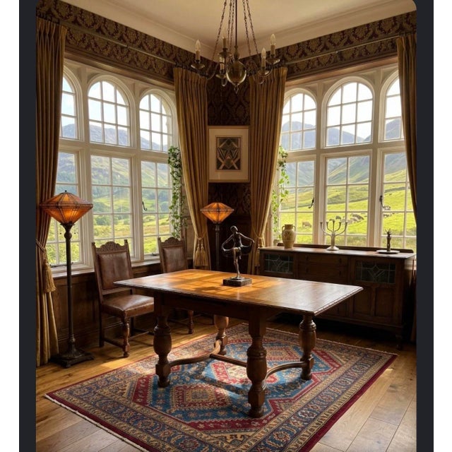 Elevate your dining space with this exceptional early 20th-century Jacobean Revival draw-leaf refectory table. Masterfully...