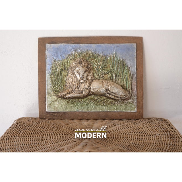 Very unique vintage embossed and painted aluminum lion art wallhanging. Artwork is mounted on a thin sheet of plywood....