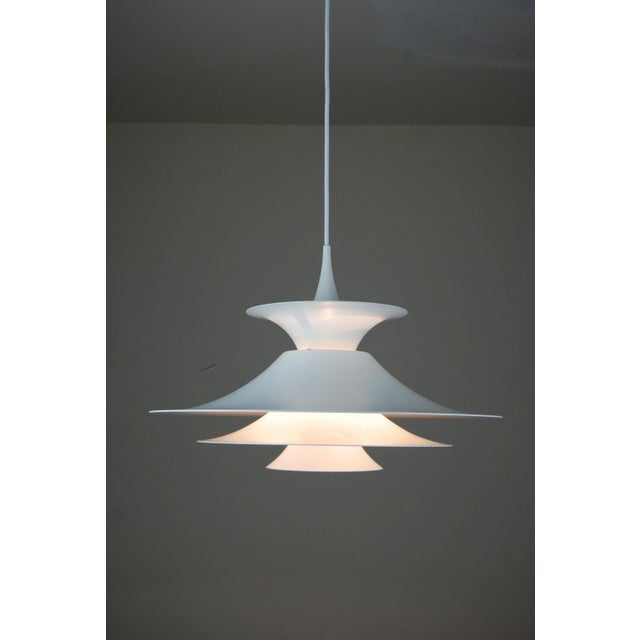 This white Radius pendant was designed by Erik Baslev for Fog and Mørup. This piece has an attribution mark, I am sure...