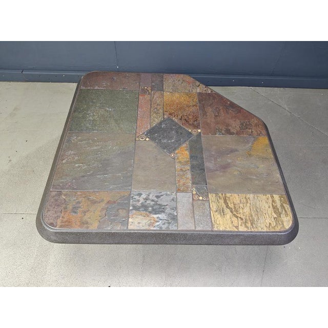 Brutalist slate and natural stone top coffee table with inlaid copper and brass. Good condition. Very much in the style of...