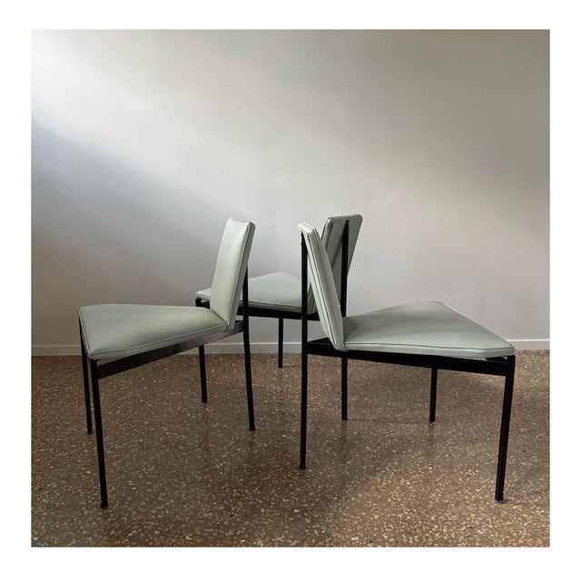 Rare set of 3 dining chairs with a striking black lacquered metal frame, seat and backrest upholstered with a light...