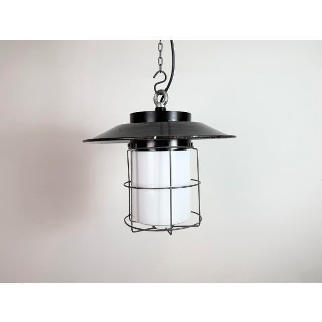 Vintage Industrial lamp made by Elektrosvit in former Czechoslovakia during the 1960s. It features a bakelite top, a gray...