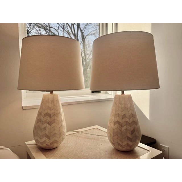 Pair of ivory and white lamps with chevron-pattern inlay and ivory-colored linen shades, attributed to Serena and Lily.