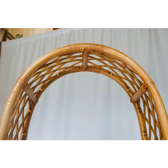 This 5 shelf midcentury rattan étagère features a lattice work detail around the sides and tapers up to a rounded top....