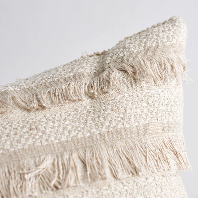 This pillow features Acadia with a Knife Edge finish. A horizontal fringed stripe, this pattern derives from a textile in...