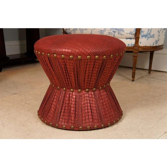 Ruben de Saavedra hourglass stool in embossed printed cotton upholstery with brass tacks. Looks like leather upholstery.