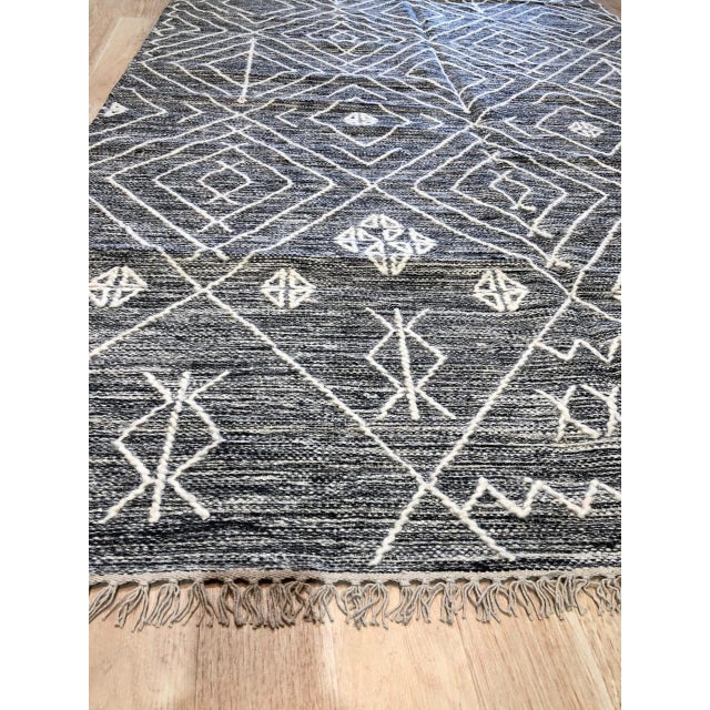 Luxurious Kilim Charcoal Handmade Wool Rug, Country of Origin: India. This striking flat-woven kilim showcases the...