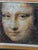 The composition reinterprets Leonardo da Vinci’s Mona Lisa through a Pop Art influenced photo mosaic structure, where the...
