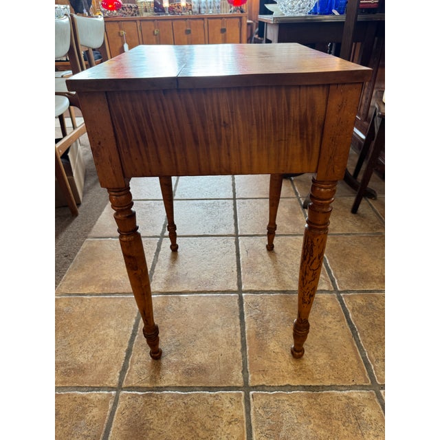 This charming antique occasional table features stunning tiger (curly/flame) maple with bold, wavy figuring that catches...