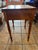 This charming antique occasional table features stunning tiger (curly/flame) maple with bold, wavy figuring that catches...