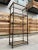 Vintage Jansen French style 5-tier glass and aged brass plated étagère, made in Italy for Mastercraft, circa mid-twentieth...