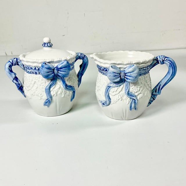 These are so lovely. A set of ceramic Creamer and Covered Sugar Bowl featuring a French Cornflower Blue Ribbon and Bow on...