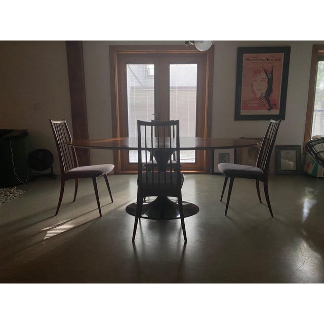 Set of four vintage Mid-Century Modern dining chairs. Tall spindle backs with a gently curved crest rail, tapered saber...