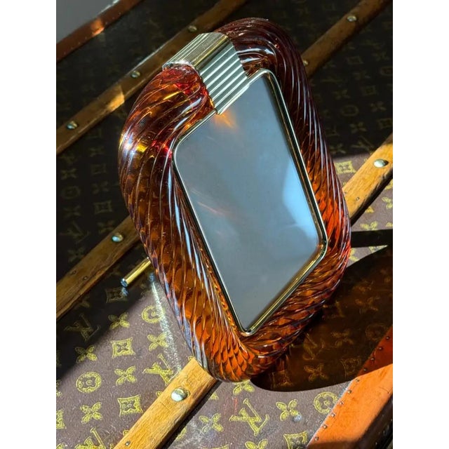 This beautiful vertical photo frame is purely in the vénitien glass manufacturing tradition.The technique used to get this...