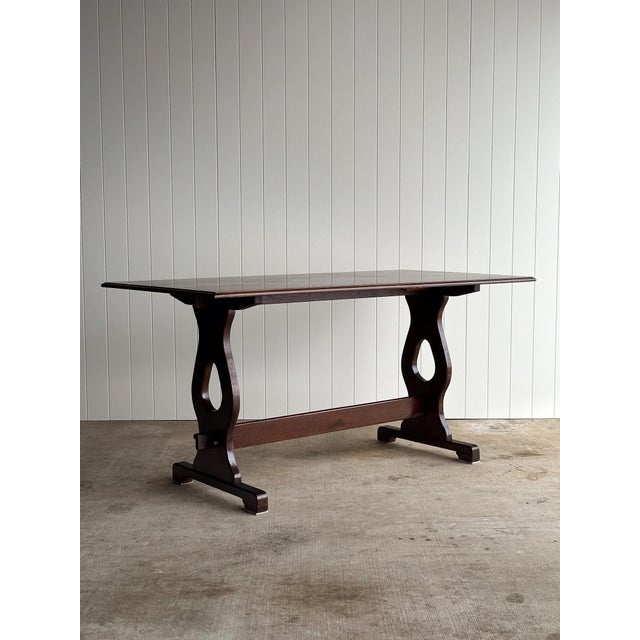 Antique English oak trestle dining table with rectangular plank top and beveled edge. Sculpted pedestal legs with pierced...