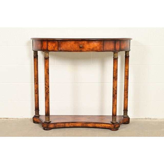 A gorgeous French Empire or Neoclassical style demilune console table In the manner of Maitland Smith USA, Circa Late 20th...