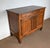 This regional sideboard, in solid light oak, has a long drawer in the waist that opens with two brass ring handles....