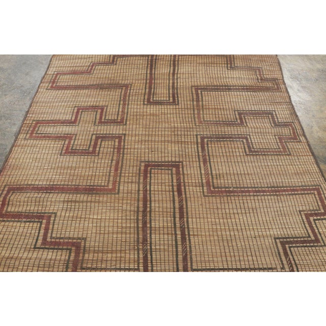 This vintage Moroccan mat is a primitive 6x7 Tuareg rug from the nomadic tribe of the same name. Handwoven with reeds and...