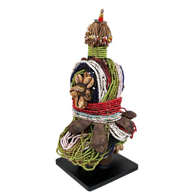 Superb African Fali fertility doll decorated with multiple layers of beads and cowrie shells, as well as leather amulets....