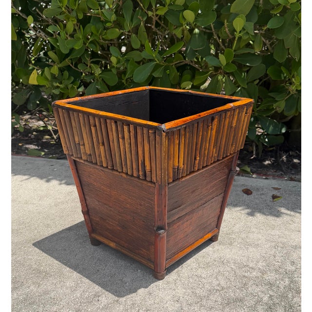 A handsome vintage square cachepot crafted with bamboo trim, vertically wrapped bamboo detailing, and wood panel...
