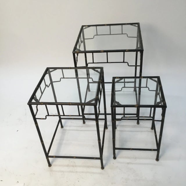 Pretty and practical set of 1980 -vintage glass top tables . Black with gold colored details. Can be stock together for...