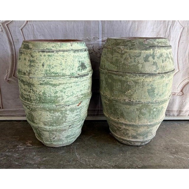 An exceptionally charming and atmospheric pair of Mediterranean style barrel-form olive jars, celebrated for their...