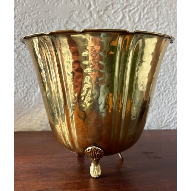 Hammered brass cachepot planter with a scalloped edge design and three brass feet. Great statement design detail. I ship...
