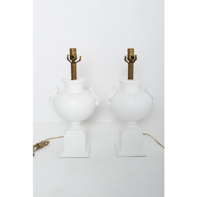 Pair of white painted plaster table lamps in the style of Dorothy Draper. Dramatically bulbous shape with large shell...