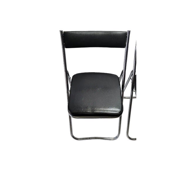 Set of 2 vintage mid century Fuji brand chairs. Black vinyl and chrome folding chairs. Very sturdy. No rips or crack but...