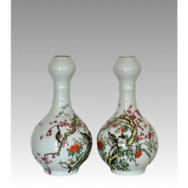 A pair of very attractive Chinese Famille Rose crisp white porcelain vases, richly enamelled and deeply glazed depciting...