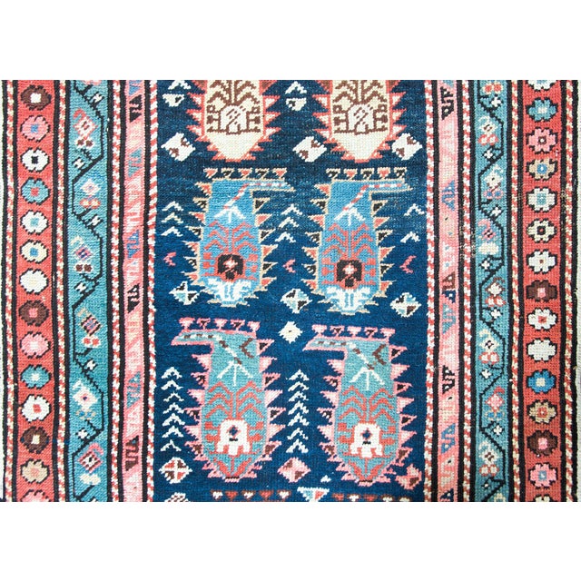 A stunning early 20th century Persian Ganjeh runner with an all-over repeated paisley pattern surrounded by a wide border...