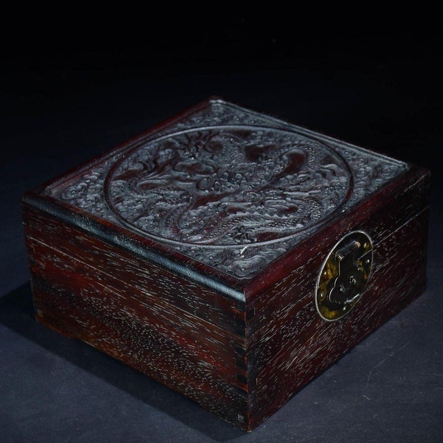 This impressive vintage Chinese box is a stunning example of traditional wood carving. Crafted from dense, dark hardwood...