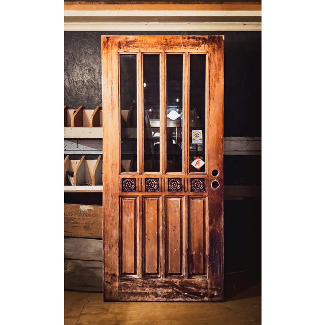 A deeply handsome and sturdy Mid-Century hand carved wooden door.