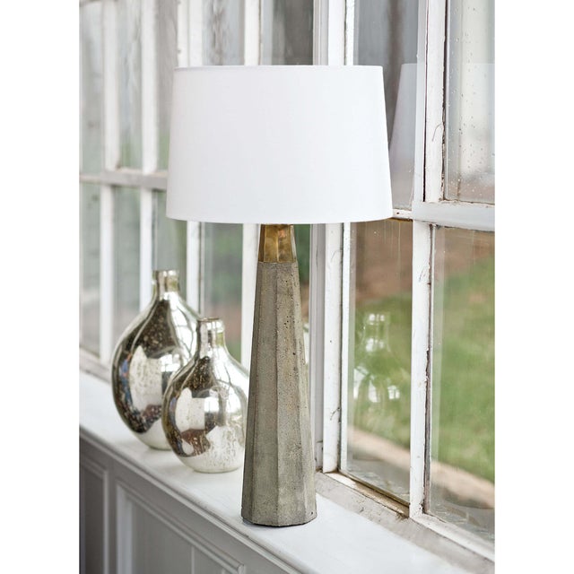 Coupling natural finishes with a long, tapered hexagonal concrete column long, the Beretta Concrete Table Lamp pairs...