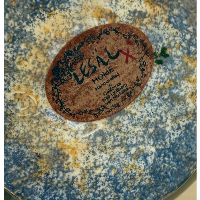 Charming hand-painted ceramic teapot by Lesal Home, featuring hand-painted florals with deep green leaves on a warm yellow...