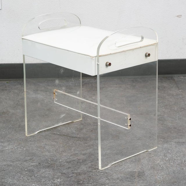 Unique thick clear lucite vanity stool with white vinyl upholstery. Seat is made up of vinyl. Unstamped example.