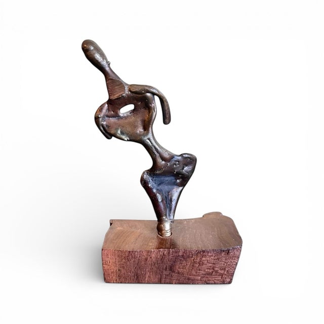An interesting vintage figural bronze sculpture on wood base. Indecipherable markings on the bronze torso; signed and...